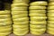Stacks of rolls yellow pvc plastic pipe on the counter in the store