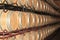 Stacks and rows of wine barrels in spanish wine cellar