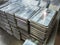 stacks of shiny metal tiles after cnc surface milling