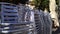 Stacks of silver metal chairs viewed from the side outside a closed room