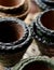 Stacks of small Mexican ceramic decorative pots with black rims