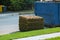 Stacks of sod rolls for new lawn and dumpster full garbage container residential construction home Installation of a modern