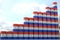 Stacks of steel drums with flag of Paraguay form increasing chart or upwards trend. Petroleum industry success concept