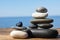 Stacks of stones on wooden pier near sea. Zen concept