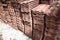 Stacks of unused old ceramic roof tiles lying on the ground of a construction site