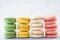 Stacks of various colorful macarons in a row. Creative design