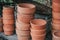 Stacks of vintage old clay flower pots on a rustic wooden surface