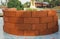 Stacks of vintage orange brick for flower pot outside the house