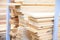 Stacks of wooden planks at building materials store. Wooden boards in a warehouse. Furniture industry