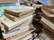 Stacks of worn-out books for sale at a used book fair in Vietnam, May 2022