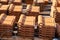 Stacks of yellow ceramic roofing tiles for covering residential building roof under construction