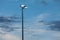 Stadium floodlight lamp post against blue evening sky