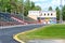 A stadium in a rural area with worn treadmills and bleachers. The concept of sports in a small town