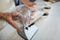 Staff checking the weight of meat packet at counter