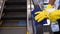 Staff cleaning the escalator hand rail in department store to prevent the spread of pandemic Covid-19 and Coronavirus, healthcare