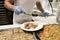 Staff in gloves serving Turkish baklava for tourists at all-inclusive hotel in Turkey. Delicious traditional sweets on a plate.