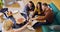 Staff At Informal Meeting In Office With Takeaway Pizza And Drinks