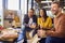 Staff At Informal Meeting In Office With Takeaway Pizza And Drinks