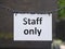 Staff only sign hanging from metal chains