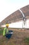 Staff in uniforms and helmets are checking and recording in the journal of the parabolic solar rail.