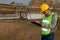 Staff in uniforms and helmets are checking and recording in the journal of the parabolic solar rail.