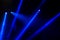 Stage lights. Several projectors in the dark. Multi-colored light beams from the stage spotlights on the stage in the smoke at the