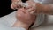 Stage of the procedure is carboxytherapy in the beauty salon. Close-up. The hands of the beautician in gloves with white napkins c