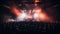 Stage at a rock concert. Crowd listening to music with neon lights and smoke. Audience at a live nightclub performance venue.