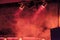 Stage spots illuminates red haze at live performance