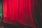 Stage with velvet red curtain in theater cinema, empty old-fashioned elegant theatre wooden stage with red cloth drapes curtains