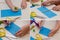 Stages of creating a children`s craft flag from colored paper