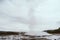 Stages of the eruption of the famous Strokkur Geyser In Iceland on a cold cloudy afternoon. Giant blue bubble right before the