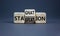 Stagflation or stagnation symbol. Businessman turns cubes, changes the word stagnation to stagflation. Beautiful grey background,
