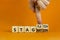 Stagflation or stagnation symbol. Businessman turns cubes, changes the word stagnation to stagflation. Beautiful orange table