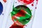 A stain of red paint in a can of green paint. A palette of paints