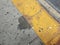 Stain or spill on grey cement with yellow bumps