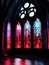 Stained gl windows lit up with a mysterious glint of crimson light Gothic art. AI generation