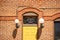 Stained Glass Saloon Window Above a Bright Yellow Door