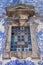 Stained glass window and azulejo tiles on church facade in Porto, Portugal. Traditional portuguese exterior ornament.