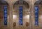 Stained glass windows and 7th and 6th of the Fourteen Stations of the Cross inside Christ the King Catholic Church in Dallas