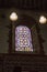 Stained glasss window and lamps in church at dover castle