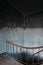 Stained wall and staircase in abandoned house