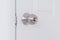 Stainless door knob,Handle on white wood door,Closeup door knob.