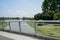 Stainless handrail of bridge over river in sunny summer