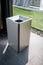 Stainless modern silver square shape trash bin on dark floor