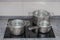 Stainless saucepans on electric stove in  kitchen