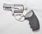 A stainless steel 357 magnum revolver with a black handle