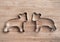 Stainless steel bear shapes on wood board.