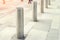 Stainless steel bollard entering pedestrian area on Vienna city street. Car and vehicle traffic access control