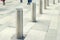 Stainless steel bollard entering pedestrian area on Vienna city street. Car and vehicle traffic access control